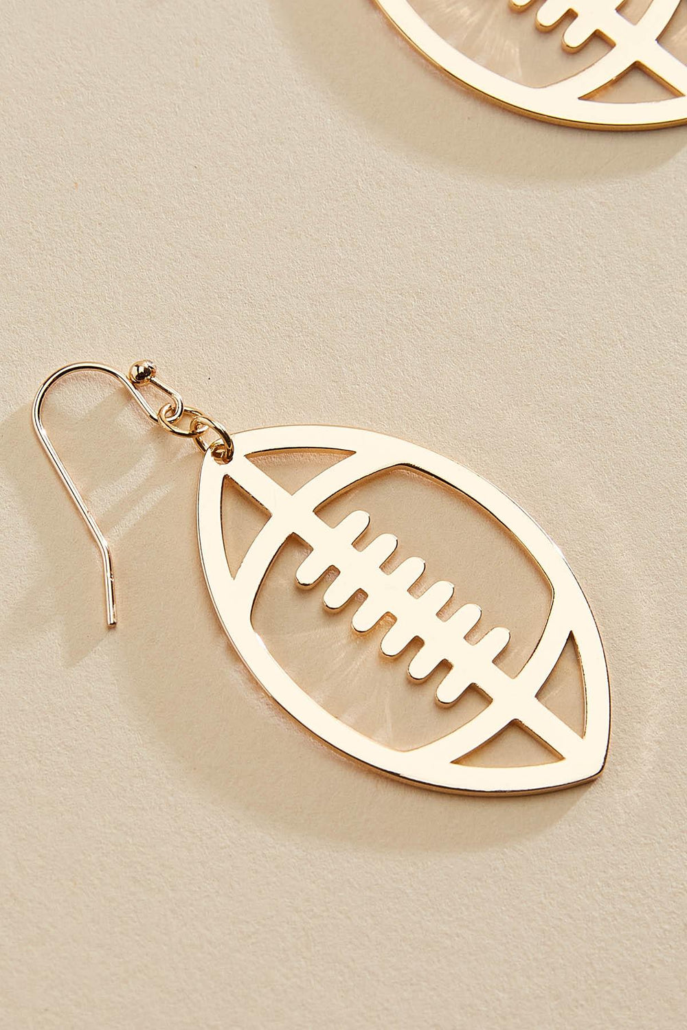 gold football cut out earrings Versona Jewelry